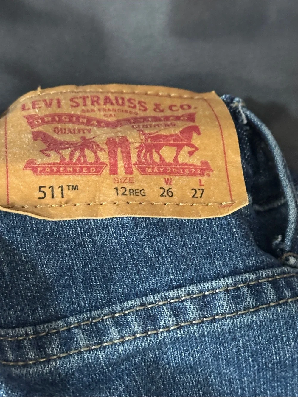 Levi's Straight Men’s Jeans in Medium Blue with Red Waistband Accent